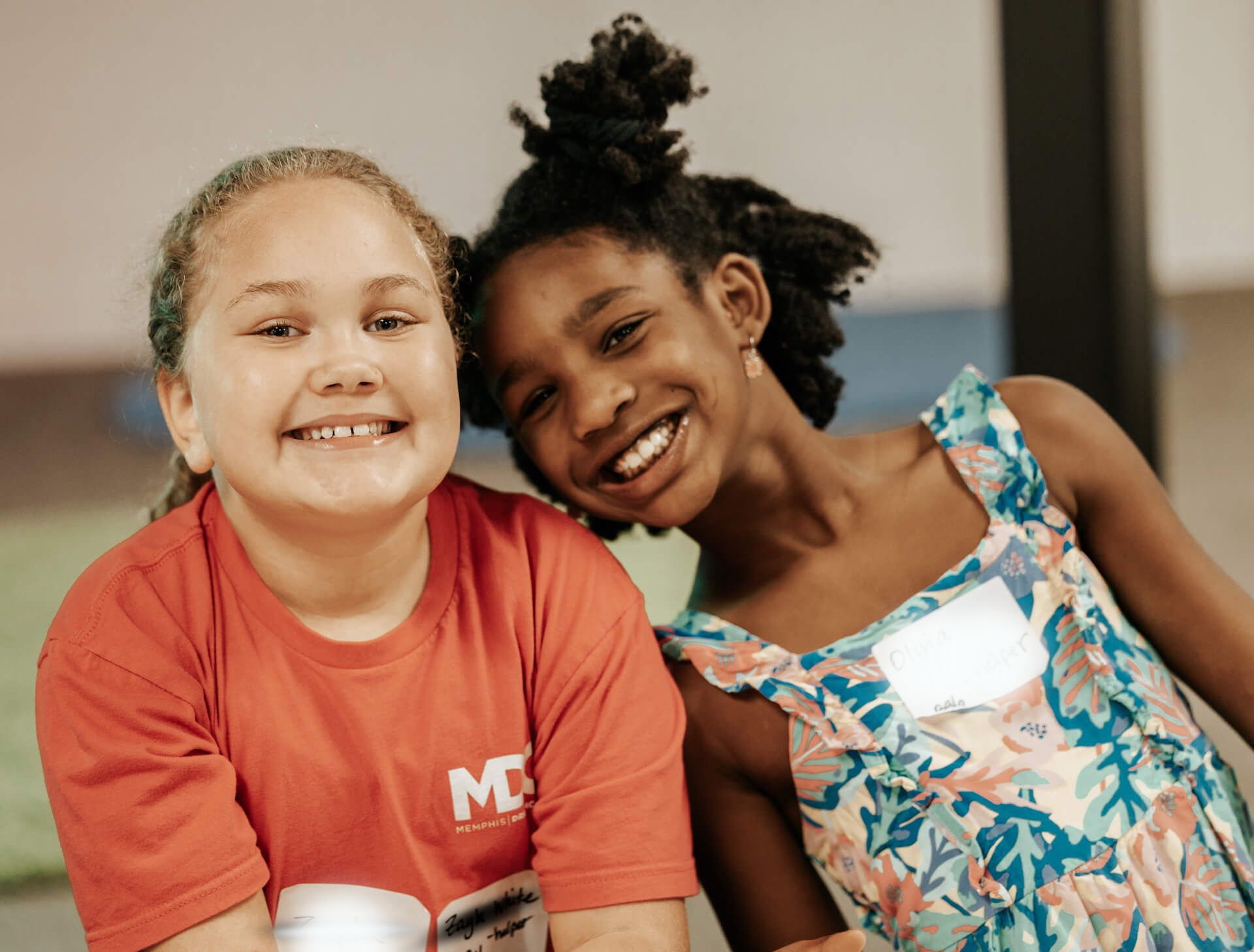 two young girls smiling at camera