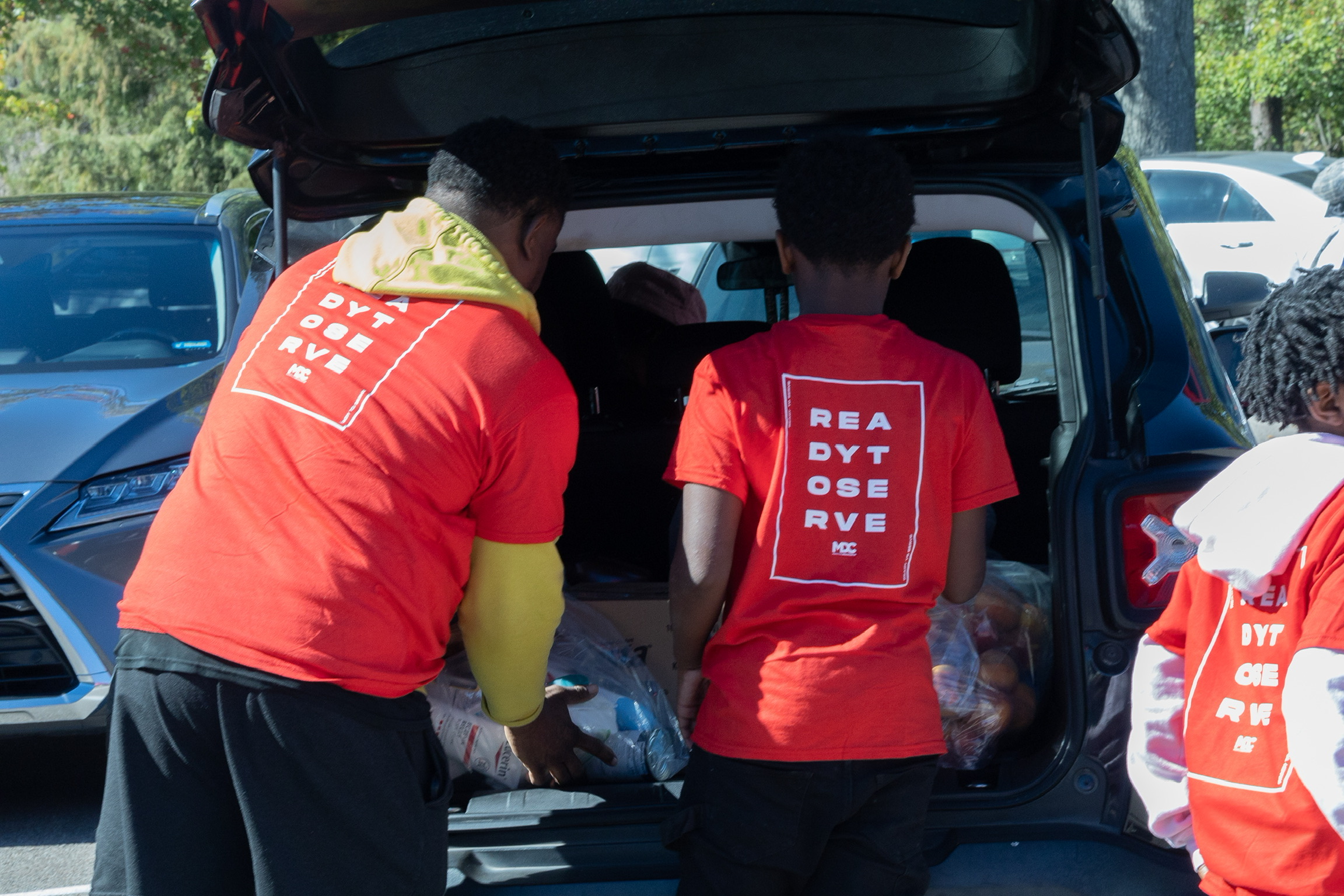 Volunteers loading groceries